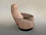 a beige chair with a black base on a gray floor