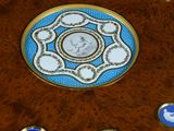 a wooden table with a blue and white design on it