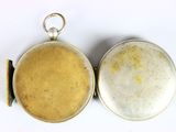 two silver and gold lockes sitting on a white surface