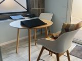 two chairs and a table in a small room