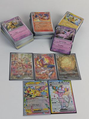 a lot of different pokemon cards on the table