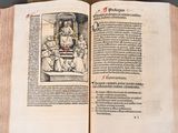 an open book with a picture of a man sitting on a throne