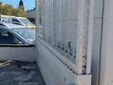 a white truck with a metal gate in the back of it