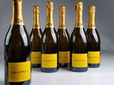six bottles of champagne are lined up in a row
