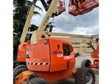 a large orange crane sitting on top of a parking lot