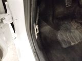 a close up of a car ' s floor with a dirty floor mat