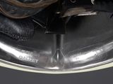 a close up of a pair of black shoes on a silver plate