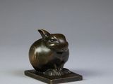 a bronze figurine of a pig on a base