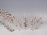 several glasses are lined up in a row on a white surface