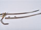 a pair of swords with a gold handle and a pair of scissors