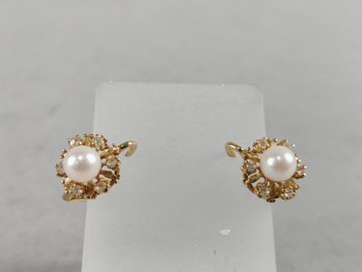 a pair of pearl and diamond stud earrings