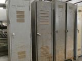 several metal lockers are lined up in a large room