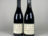 deux bouteilles de vin posées l'une à côté de l'autre sur une table