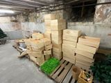 a pile of wooden boxes sitting on a pallet next to a tree
