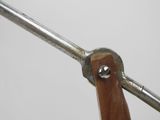 a close up of a metal object with a wooden handle