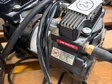 a small air compressor sitting on top of a wooden table