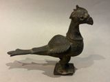 bronze statue of a bird on a pedestal with a white background