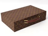 a brown and brown louis vuitton suitcase on a white surface