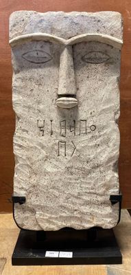 statue of a man with a face carved into it ' s face