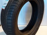 a close up of a tire on a white surface next to a wall