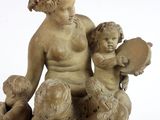 statue of a woman and two children sitting on a rock