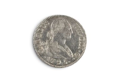 an old silver coin on a white surface with a white background