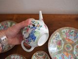 a person holding a cup and saucer in their hand