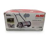 a box of a lawn mower sitting on top of a white surface