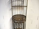 an image of a birdcage with a shelf on top of it