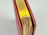 an open book sitting on top of a table next to a white background