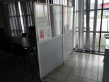 a refrigerator in the corner of a room with a table in front of it