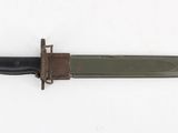 an old knife with a black handle on a white surface