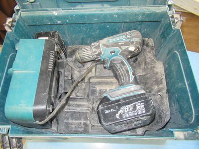 a blue tool box with tools in it on a table