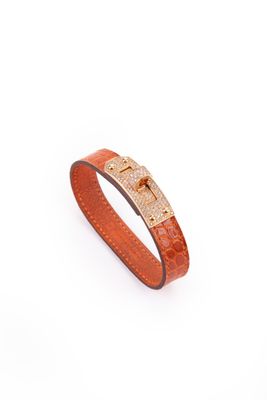 a brown leather bracelet with a gold clasp