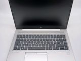 an open laptop computer sitting on top of a white table