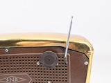 a brown radio sitting on top of a white table