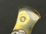 a close up of a metal object with a clock on it