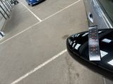 a parking meter on the side of a car in a parking lot