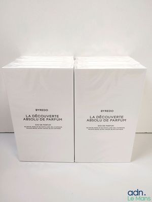 two boxes of perfume sitting on top of each other on a table