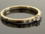 a gold ring with a diamond on top of it