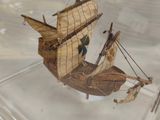 a small model of a boat in a glass case