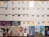 many postcards on the wall of a room