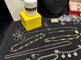 many necklaces and bracelets on display on a table