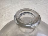 a clear glass bottle with a small hole in it