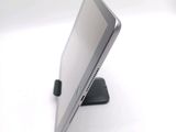 a tablet computer sitting on a stand on a white surface