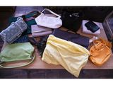 many bags and purses laid out on a table