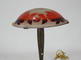 a red and white lamp sitting on top of a wooden table