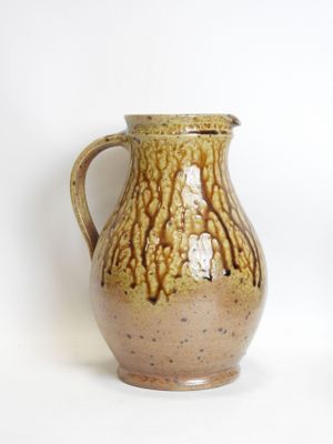 two vases sitting next to each other on a white surface