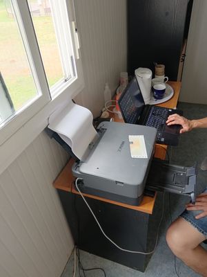 a man that is sitting at a desk with a laptop