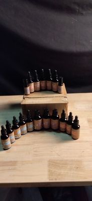 many bottles of essential oils sitting on a wooden table
